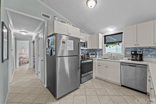 kitchen with visible vents, stainless steel appliances, light countertops, white cabinetry, and a sink