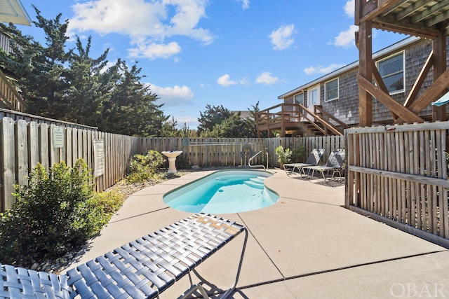 view of swimming pool with a fenced backyard, a fenced in pool, and a patio