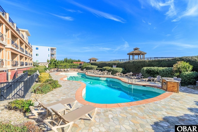 pool featuring a patio area and fence