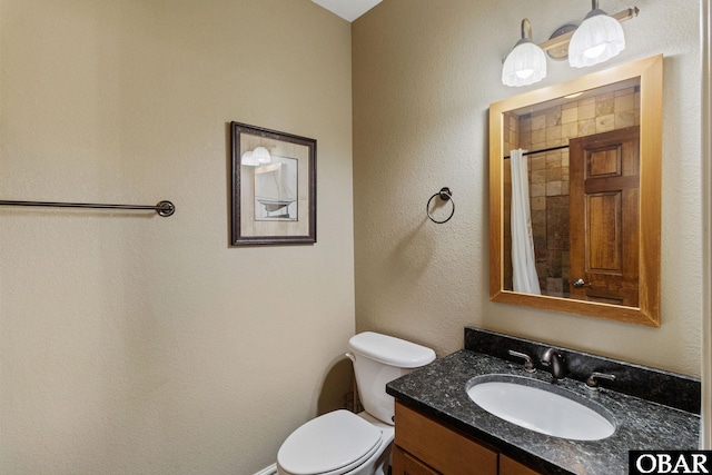 bathroom featuring toilet, a shower with curtain, and vanity