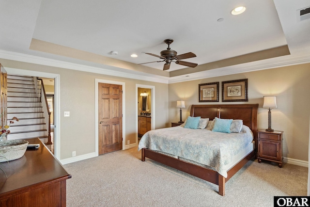 bedroom with a raised ceiling, light colored carpet, and visible vents