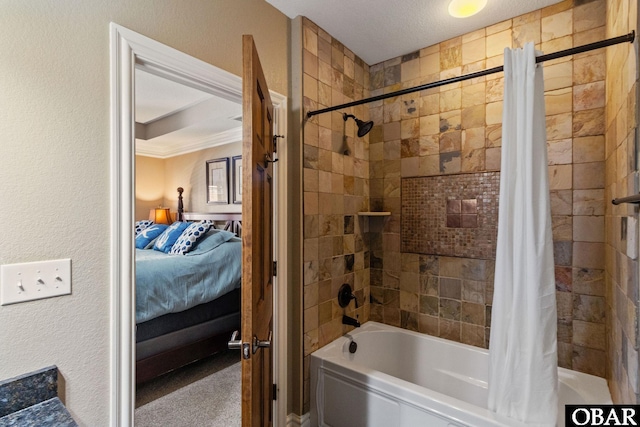 ensuite bathroom featuring a textured wall, shower / bathtub combination with curtain, and ensuite bathroom