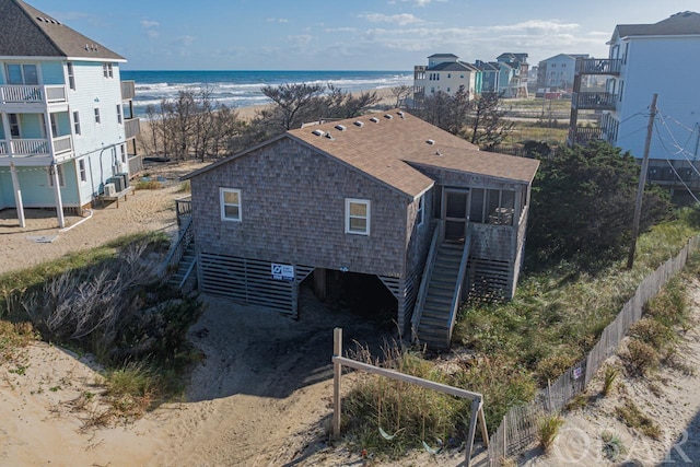 aerial view featuring a water view and a beach view