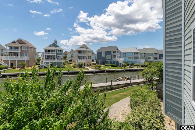 property view of water featuring a residential view and a boat dock