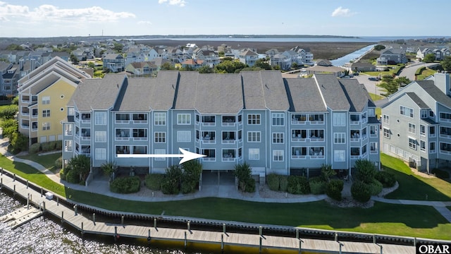 birds eye view of property with a water view and a residential view