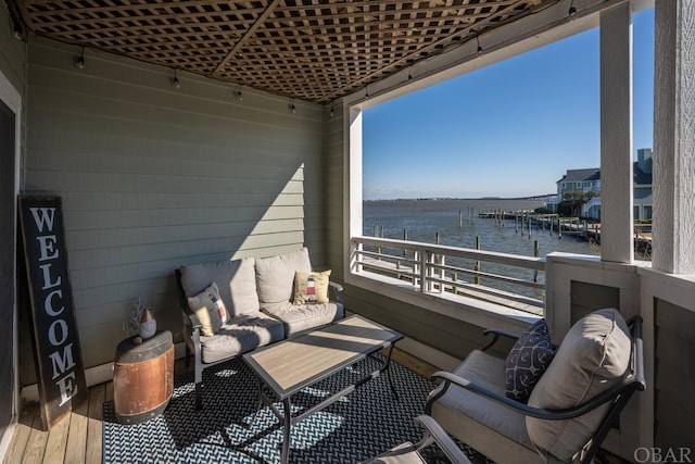 balcony with a water view and outdoor lounge area