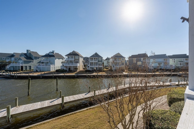 view of water feature with a boat dock and a residential view