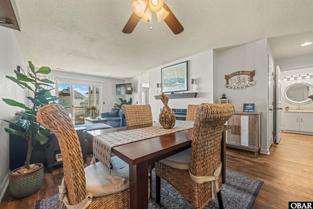 dining area with a textured ceiling, ceiling fan, wood finished floors, and baseboards