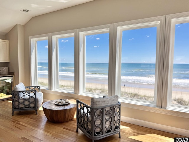103 Buffell Head Rd Lot 2, Duck, NC 27949 - sitting room with healthy amount of natural light, vaulted ceiling, wood finished floors, wine cooler, and baseboards