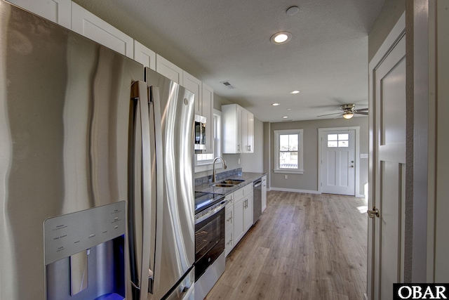 27248 Sand St Lot # 6, Salvo, NC 27972 - kitchen with appliances with stainless steel finishes, white cabinetry, light wood-style flooring, a ceiling fan, and recessed lighting