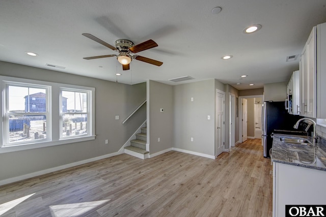 27248 Sand St Lot # 6, Salvo, NC 27972 - unfurnished living room featuring a ceiling fan, stairs, recessed lighting, and light wood-style flooring