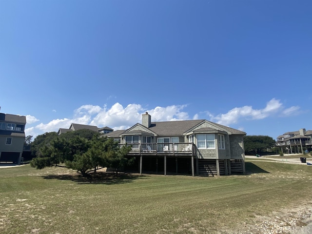 exterior space featuring a deck, a chimney, and a front yard