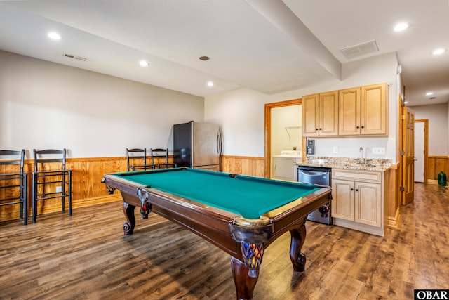 recreation room with washer / dryer, visible vents, wood finished floors, and wainscoting