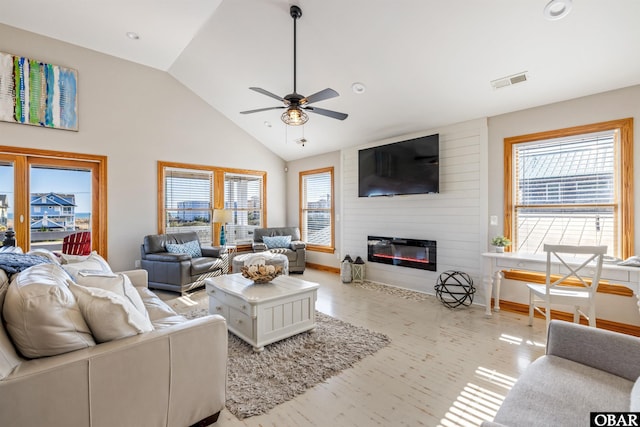 living room with a ceiling fan, a large fireplace, visible vents, and high vaulted ceiling