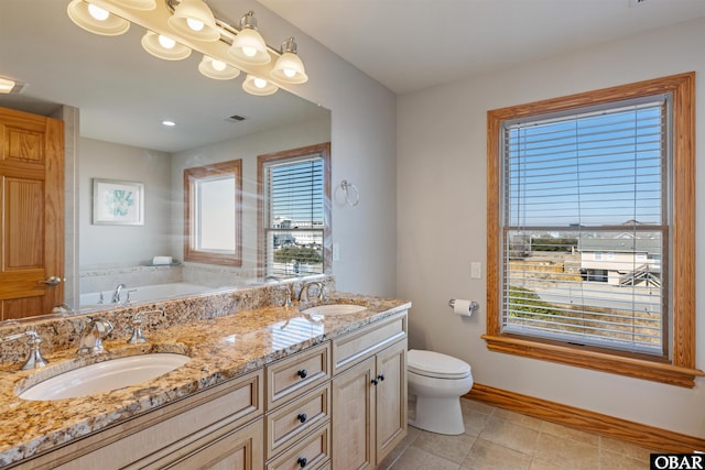 bathroom featuring toilet, visible vents, baseboards, and a sink