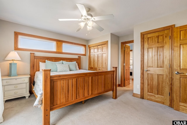 bedroom featuring a ceiling fan, light carpet, and baseboards