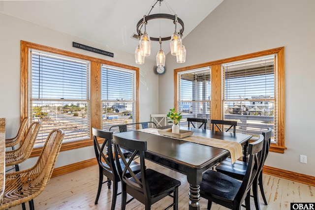 dining space with baseboards, plenty of natural light, and light wood finished floors