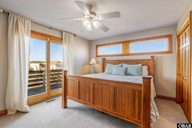 bedroom featuring multiple windows and light carpet