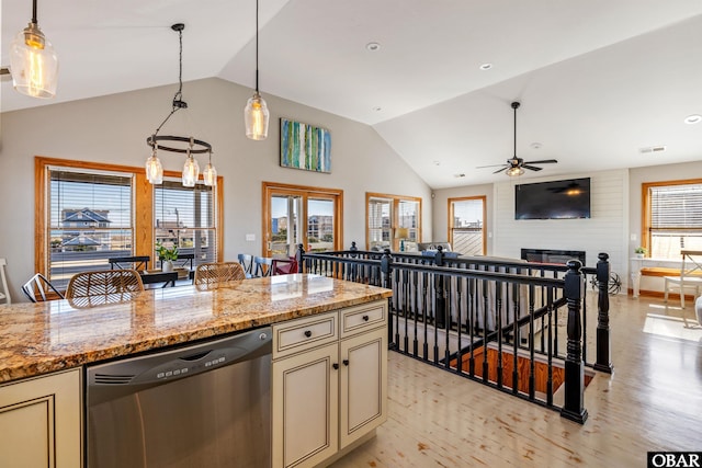 kitchen with light stone counters, a breakfast bar, open floor plan, pendant lighting, and stainless steel dishwasher