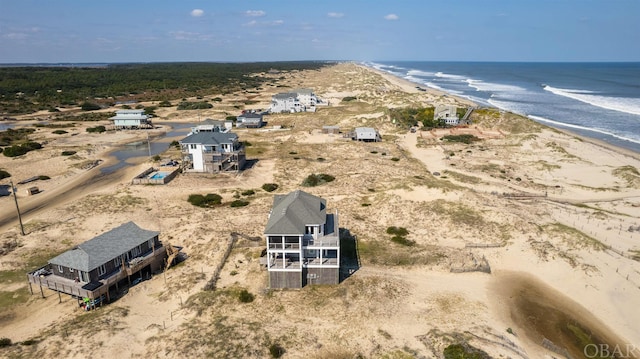 drone / aerial view featuring a water view and a beach view