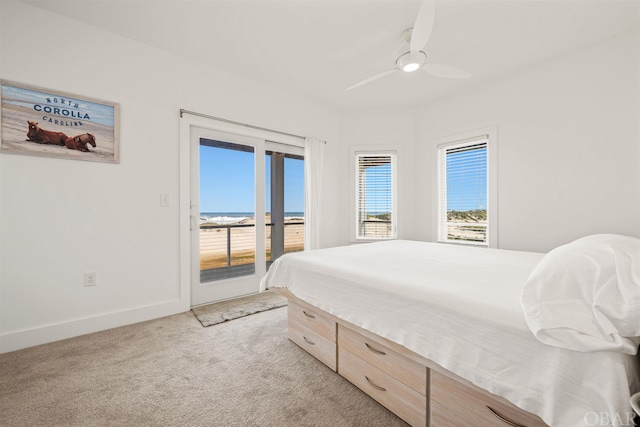 bedroom featuring ceiling fan, light carpet, a water view, baseboards, and access to outside