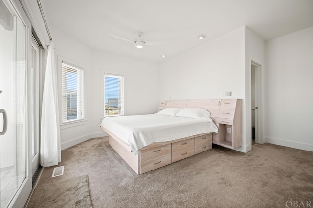 bedroom with a ceiling fan, light colored carpet, visible vents, and baseboards