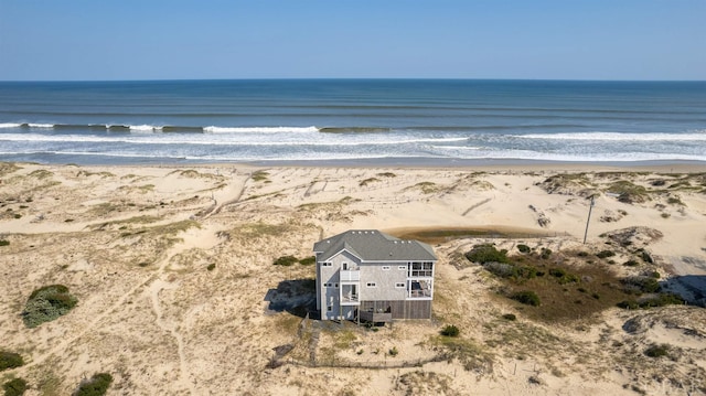 exterior space featuring a water view and a beach view