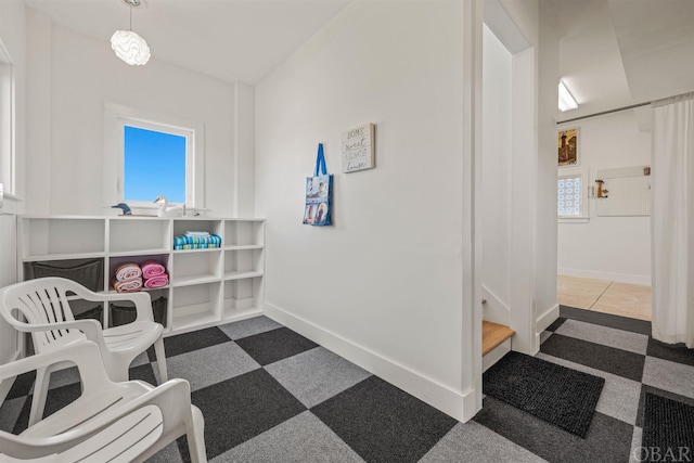 living area featuring baseboards