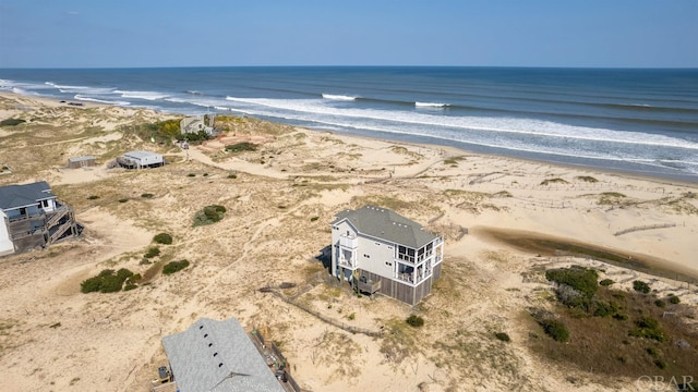 drone / aerial view with a water view and a view of the beach