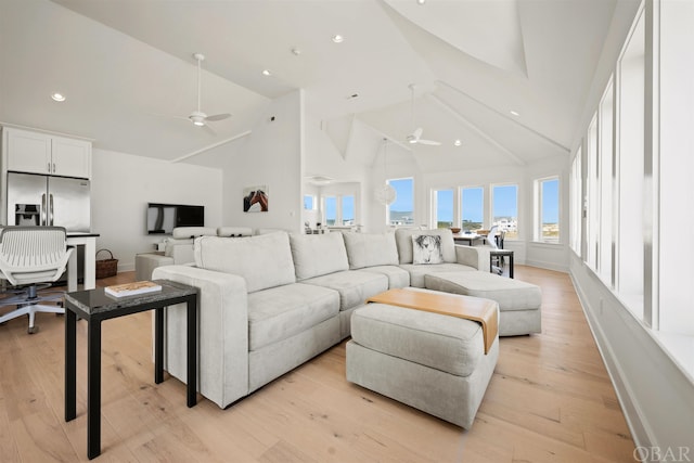 living area with a healthy amount of sunlight, light wood-style floors, and ceiling fan