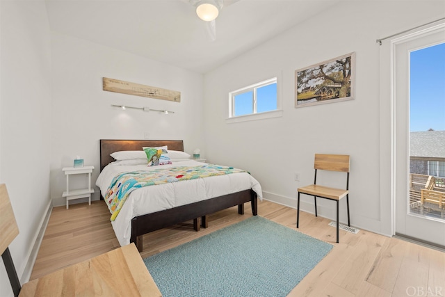 bedroom with access to exterior, ceiling fan, wood finished floors, and baseboards