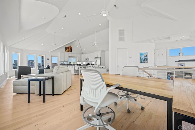 dining space with ceiling fan, light wood finished floors, and visible vents