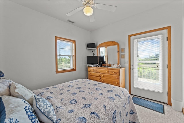 bedroom with visible vents, carpet flooring, multiple windows, and access to exterior