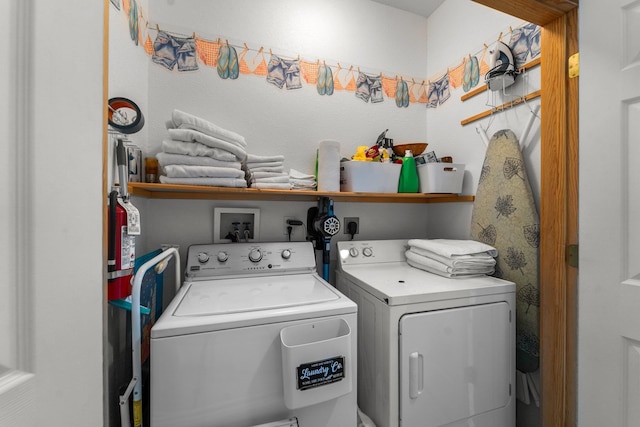 washroom with independent washer and dryer and laundry area