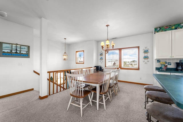 dining room featuring baseboards, light colored carpet, and an inviting chandelier