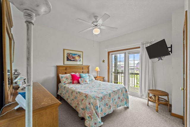 carpeted bedroom featuring access to outside and a ceiling fan