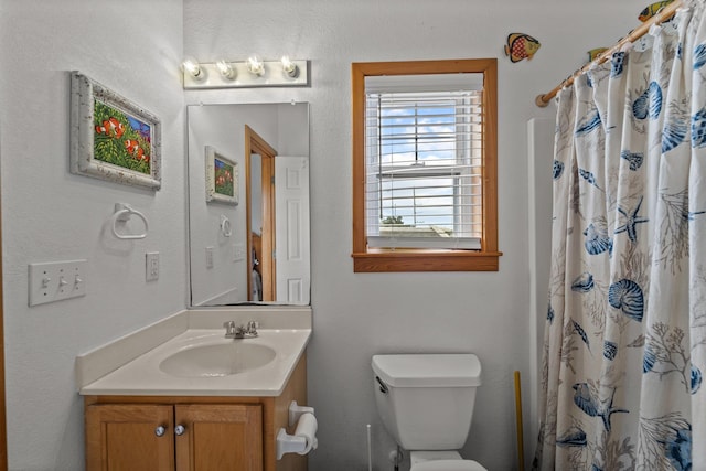 bathroom featuring toilet, a shower with curtain, and vanity