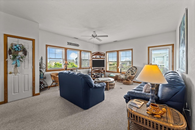 carpeted living room featuring a ceiling fan
