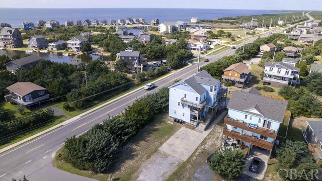 birds eye view of property featuring a water view and a residential view