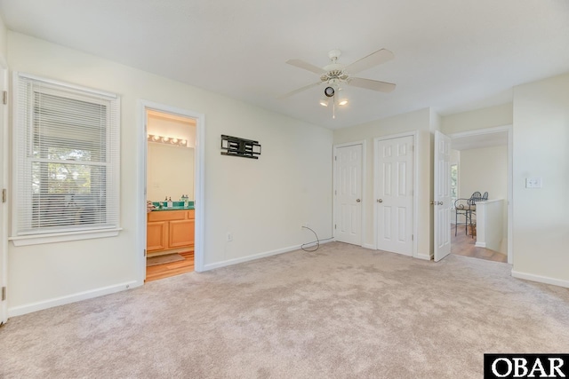 empty room featuring carpet floors, ceiling fan, and baseboards