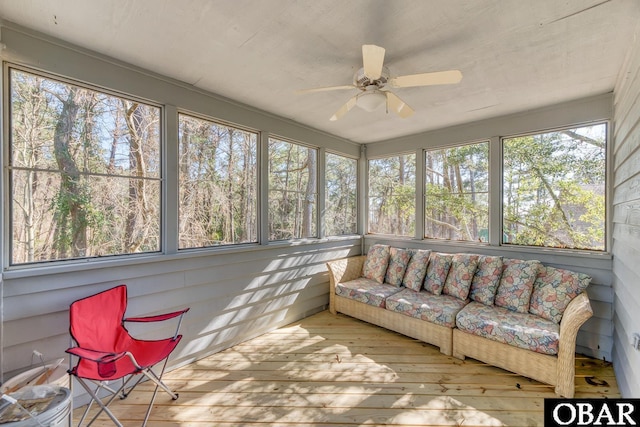 sunroom / solarium featuring ceiling fan