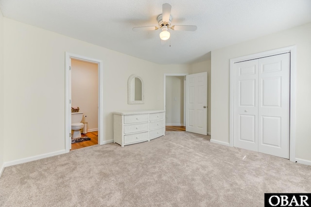 unfurnished bedroom featuring carpet, a closet, and baseboards