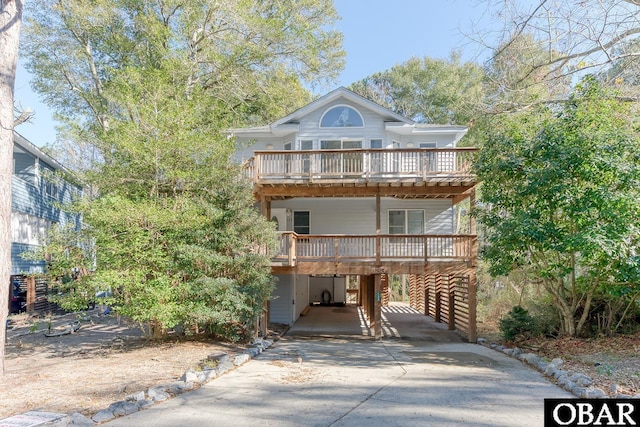 view of front of home with driveway and a carport