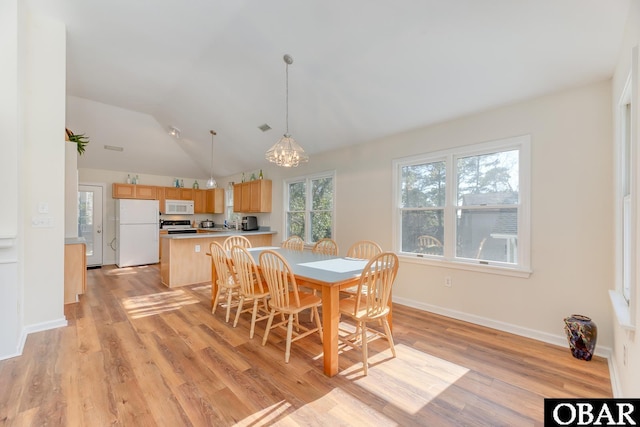 dining space featuring visible vents, baseboards, vaulted ceiling, light wood-type flooring, and a notable chandelier