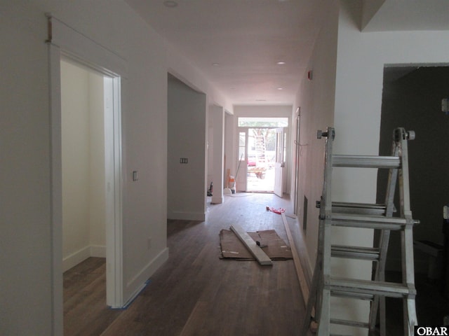 hall with baseboards and wood finished floors