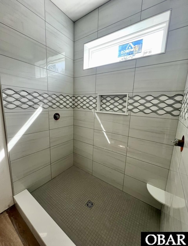 bathroom with tiled shower