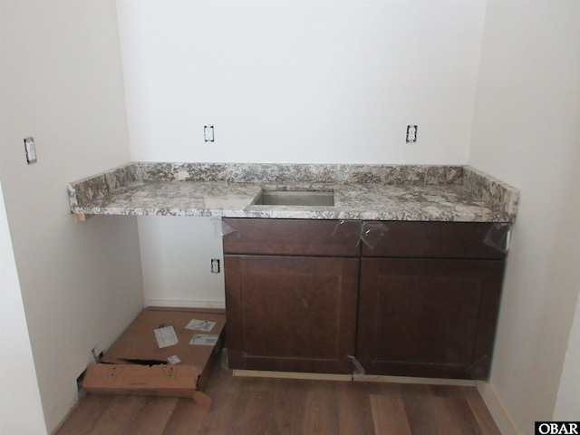 bathroom featuring a sink and wood finished floors