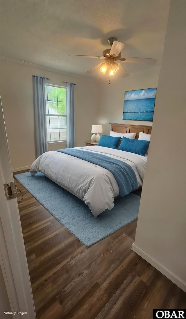 bedroom featuring wood finished floors, baseboards, and ceiling fan