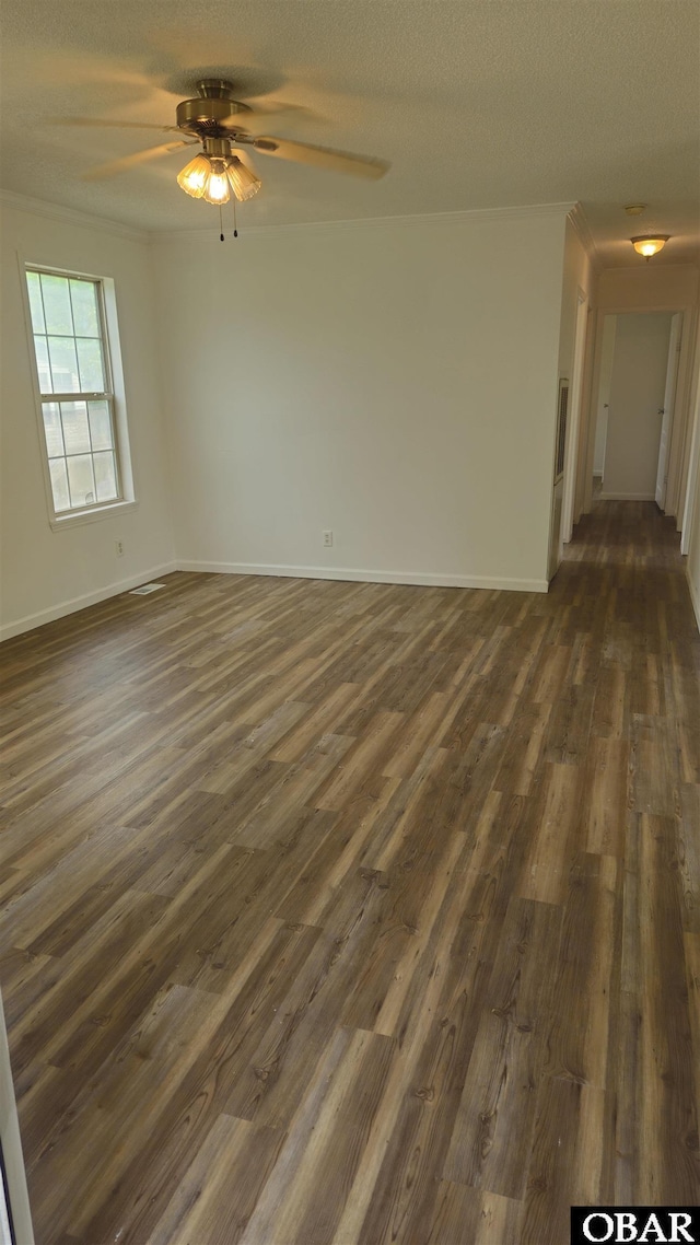 empty room with dark wood finished floors, baseboards, and ceiling fan