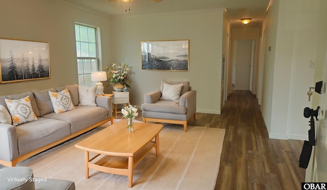 living area with wood finished floors, crown molding, baseboards, and ceiling fan